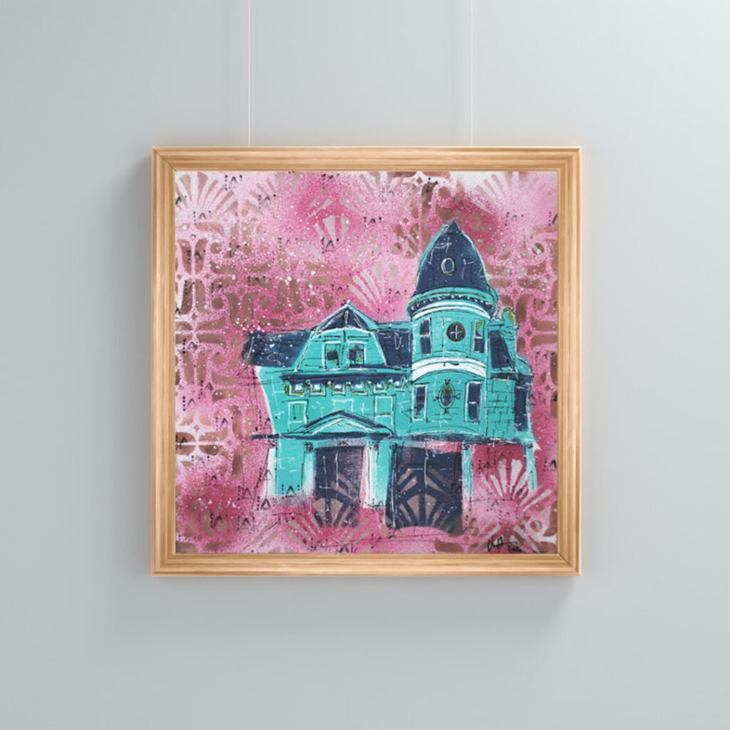 Mockup image of the 'Full Bloom' painting, depicting a Queen Anne house with a turret, showcased in a wooden frame hanging from a picture rail on a wall, adding charm to the living space